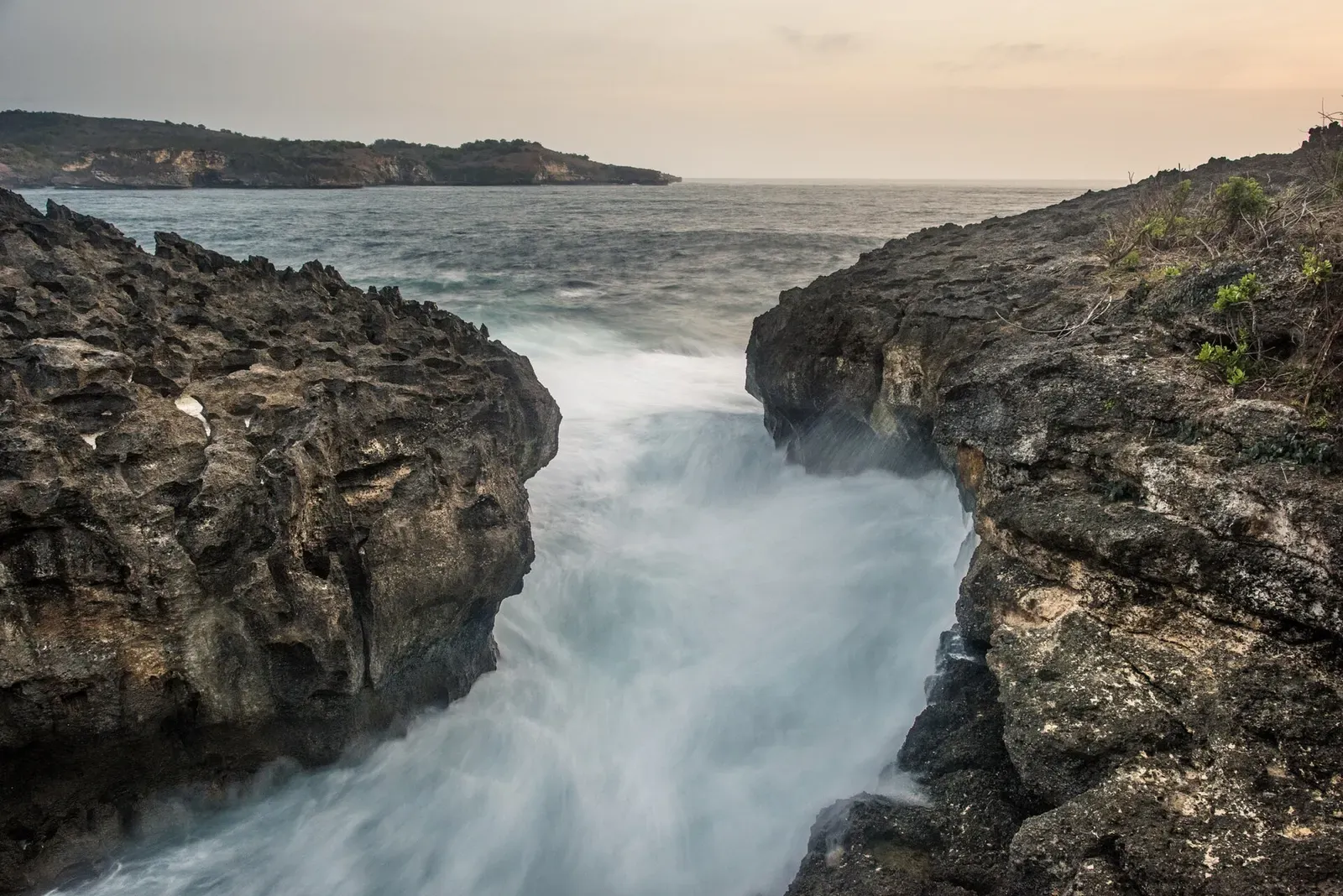 Waves surging through a rocky inlet at Angel's Billabong on Nusa Penida's coastline