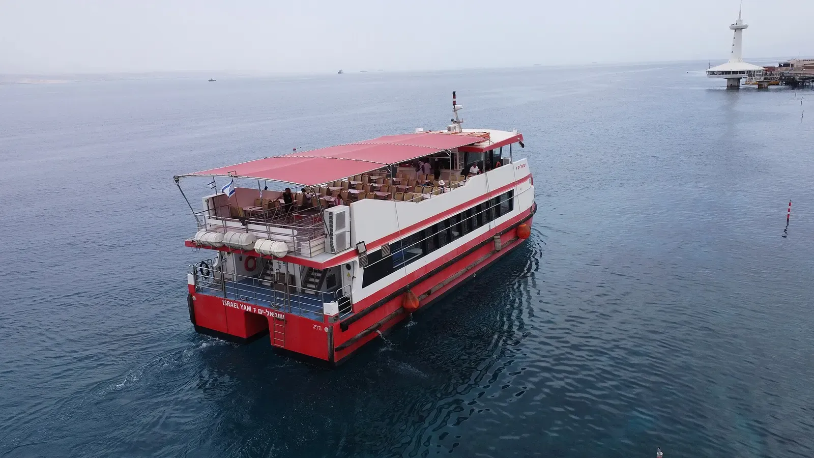 A glass-bottom tour boat cruising the calm waters off Eilat's coastal reef