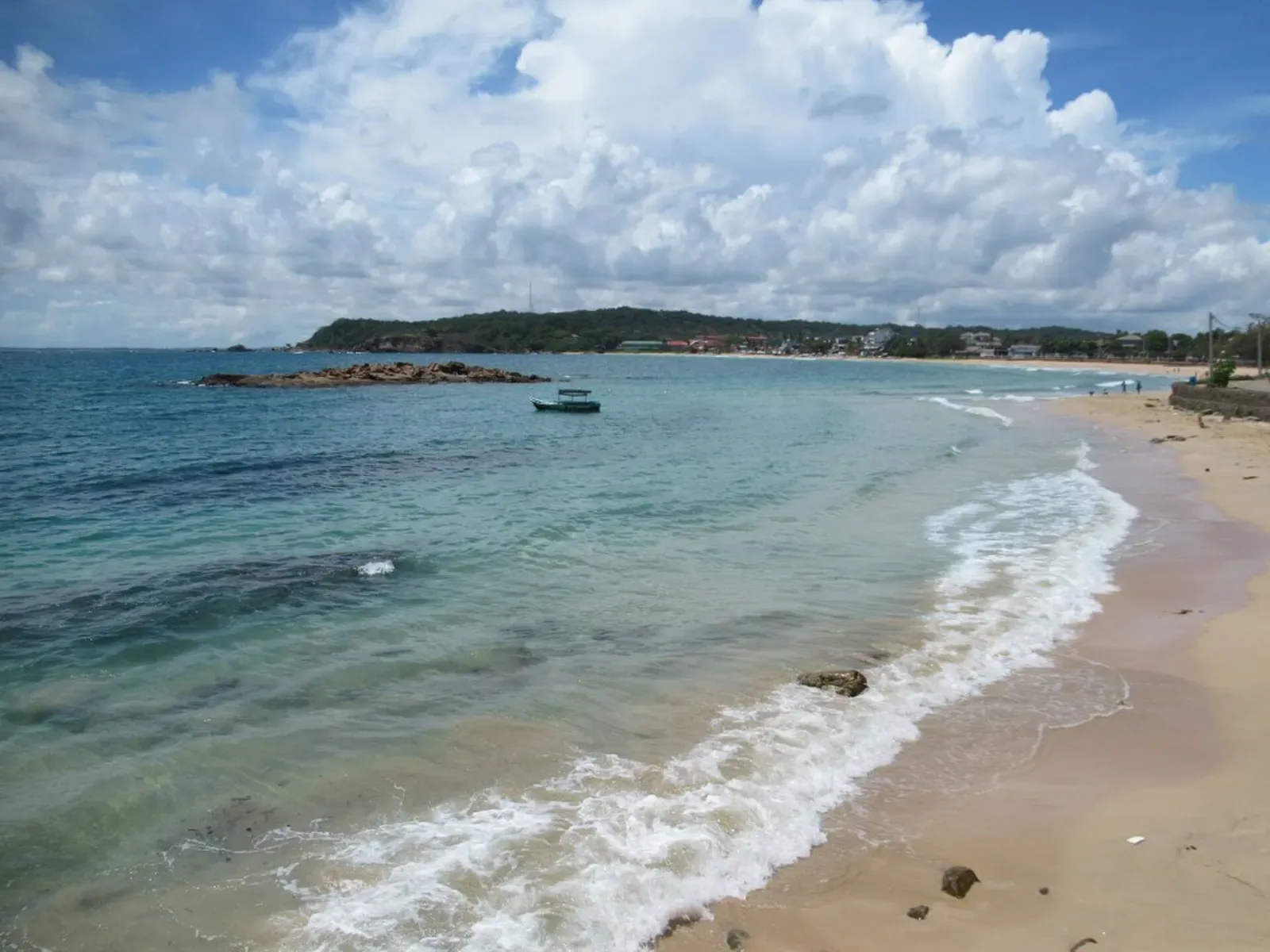 Waves rolling onto a quiet sandy beach on Dutch Bay near Trincomalee, Sri Lanka