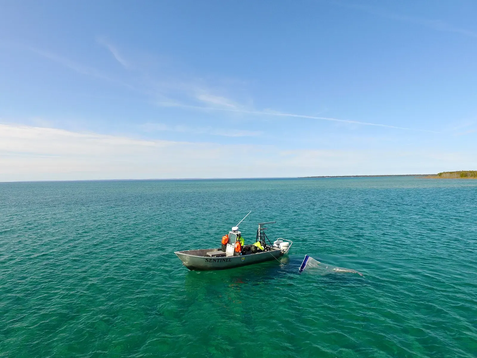 A small research boat on the calm, clear waters of Lake Huron's Thunder Bay near Alpena, Michigan.