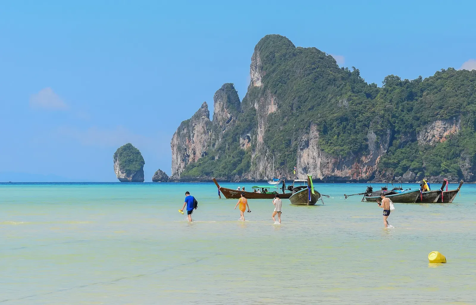 Twin limestone peaks rise over Loh Dalum beach's turquoise lagoon on Ko Phi Phi Don