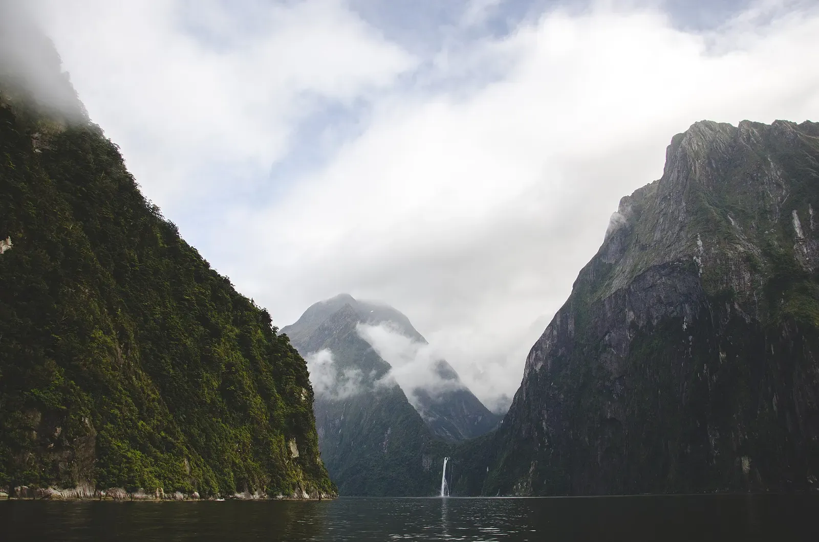 Clouds parting over the steep fjord walls of Milford Sound, Fiordland