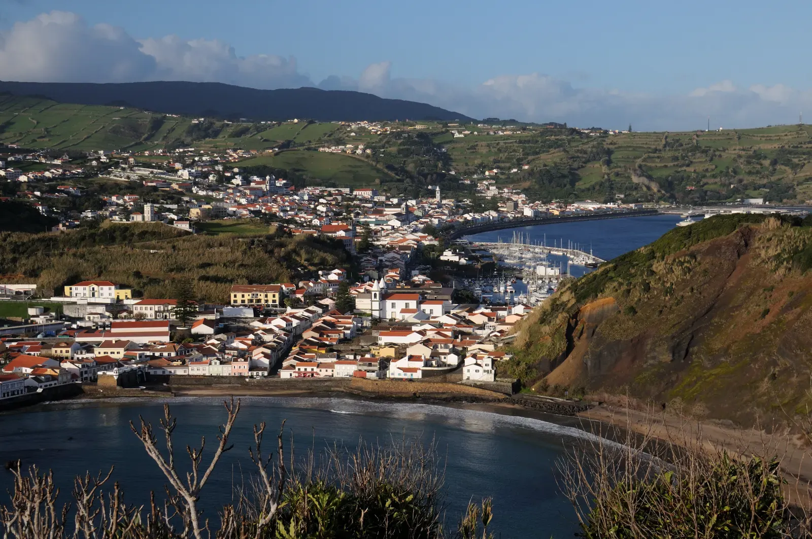 Panoramic view of Horta's marina, bay and the green slopes of Faial Island