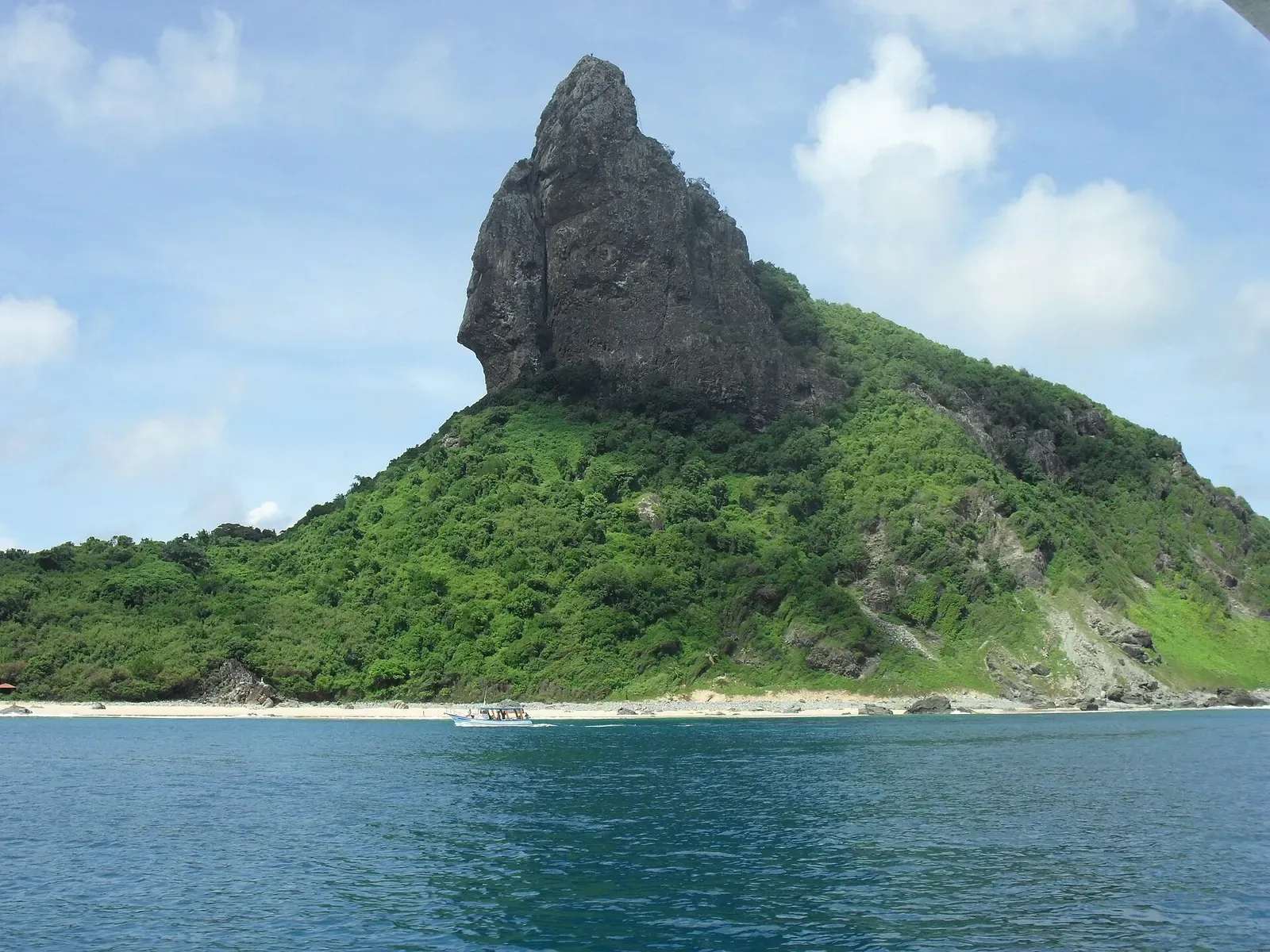 View from the water of Morro do Pico, the volcanic peak overlooking Conceição Beach in Fernando de Noronha
