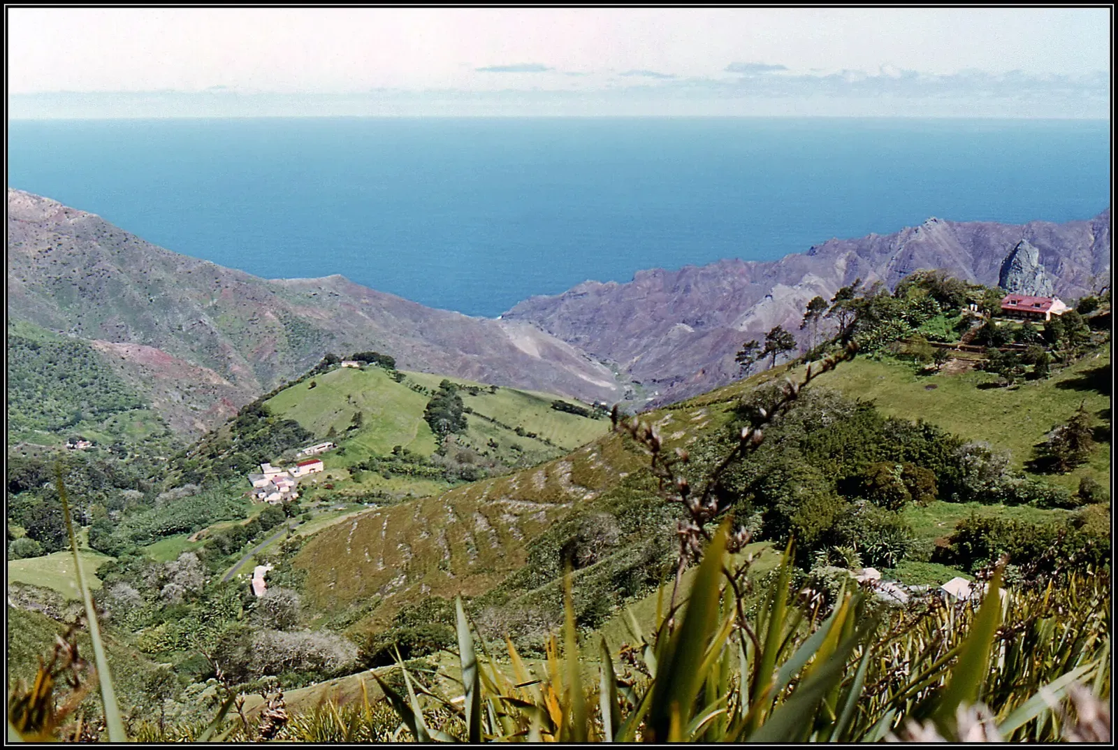 A steep volcanic ravine drops toward the ocean at Sandy Bay on St Helena's south coast.