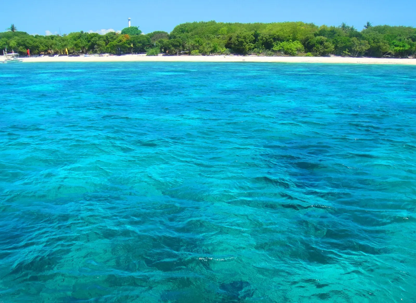 Clear turquoise reef shallows along Panglao's Alona Beach coastline