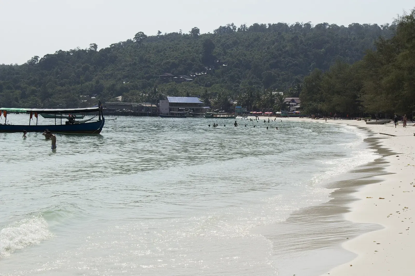 Traditional Khmer fishing boat with flag anchored in calm water near Koh Rong