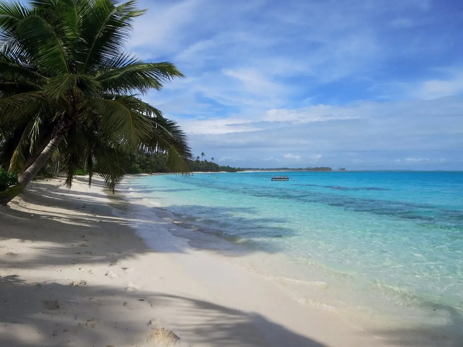 White sand beach fringed with palm trees along the lagoon shore of Direction Island, Cocos (Keeling) Islands