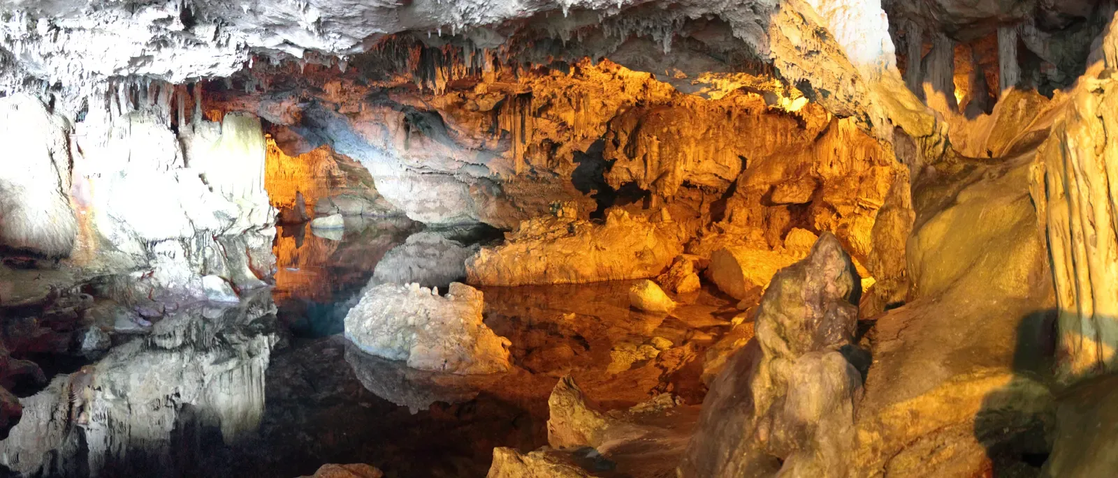 Stalactite-hung chambers and still water inside Neptune's Grotto at Capo Caccia