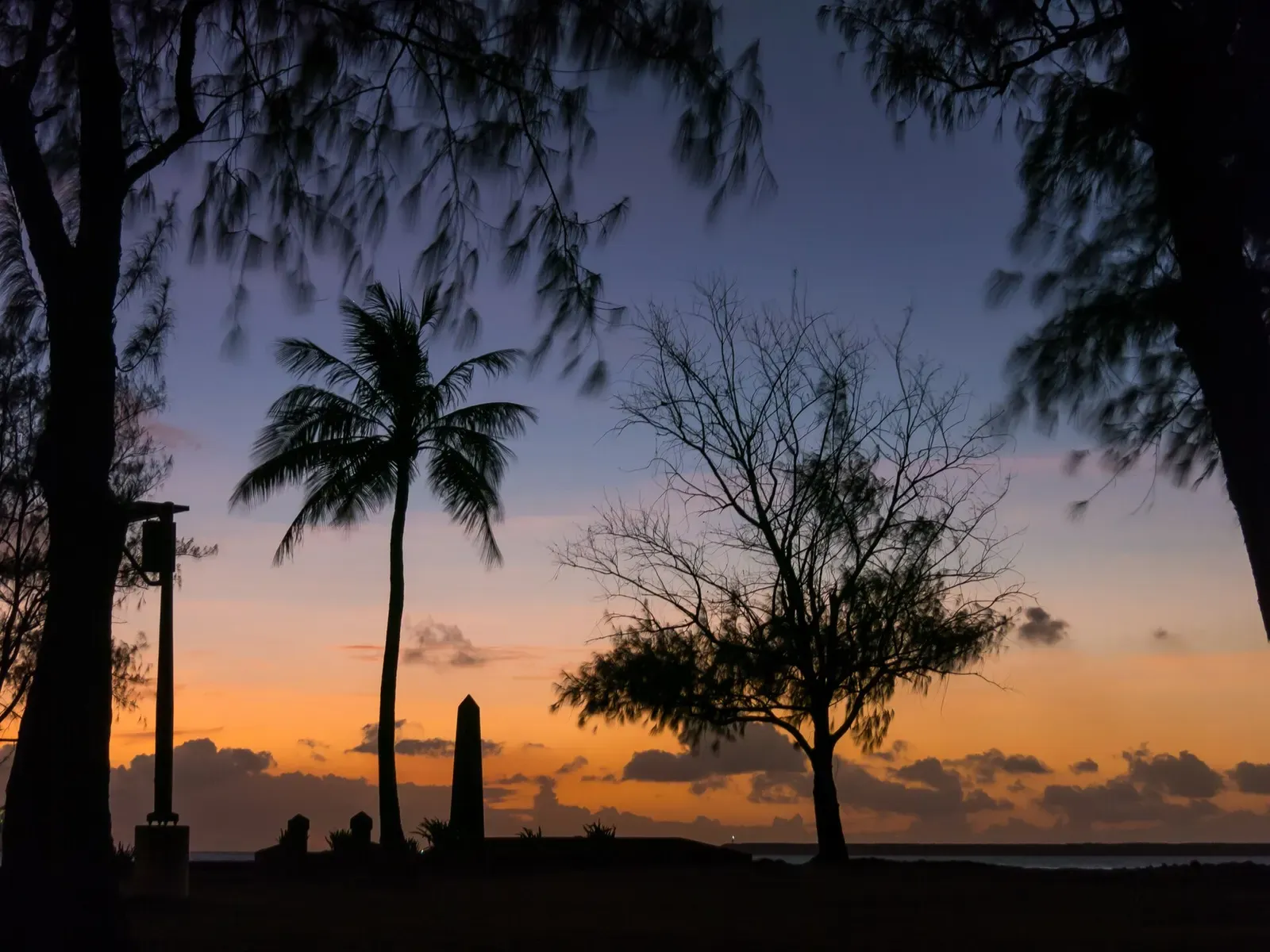 Palm trees silhouetted at dusk on Gab Gab Beach, Guam