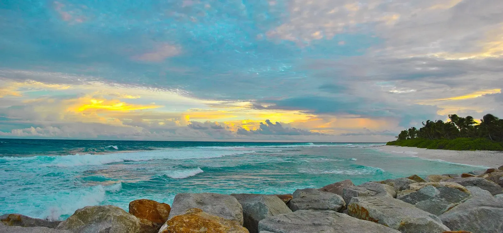 Sunset over the rocky point at Fuvahmulah Harbour, Maldives