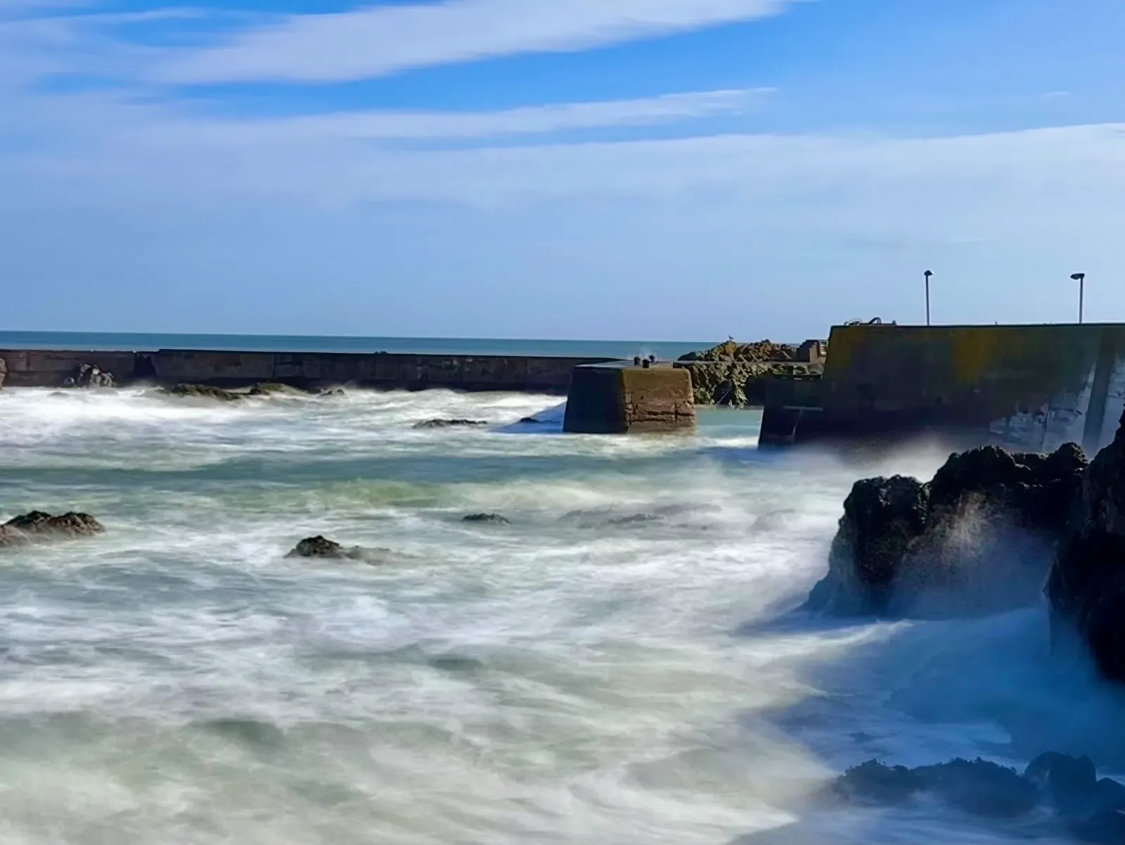 North Sea swell breaking against rocks at the St Abbs harbour mouth