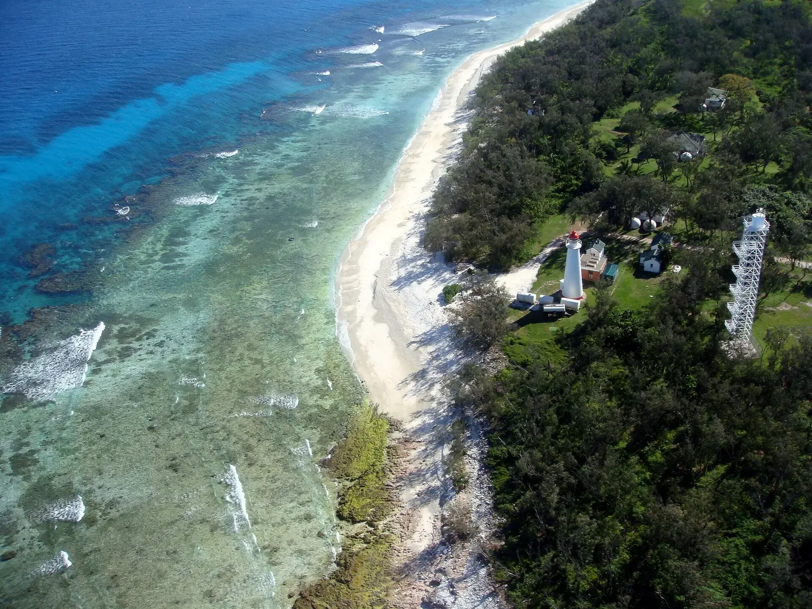 Aerial view of Lady Elliot Island's coral cay, fringing reef, and lighthouse.