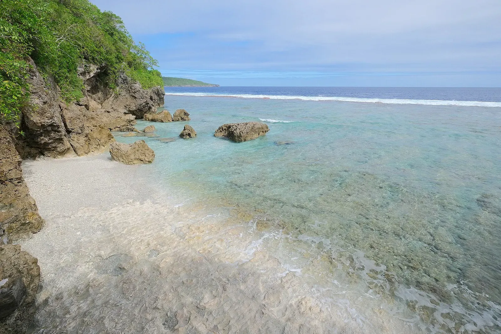 Clear turquoise cove with a white coral rock base at Pofitu, Niue