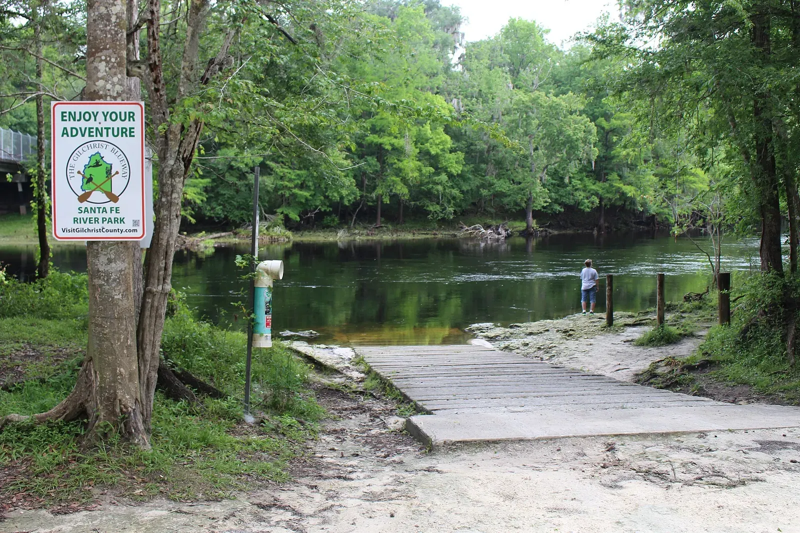 A boat ramp and dock lead into the tannic Santa Fe River at Santa Fe River Park
