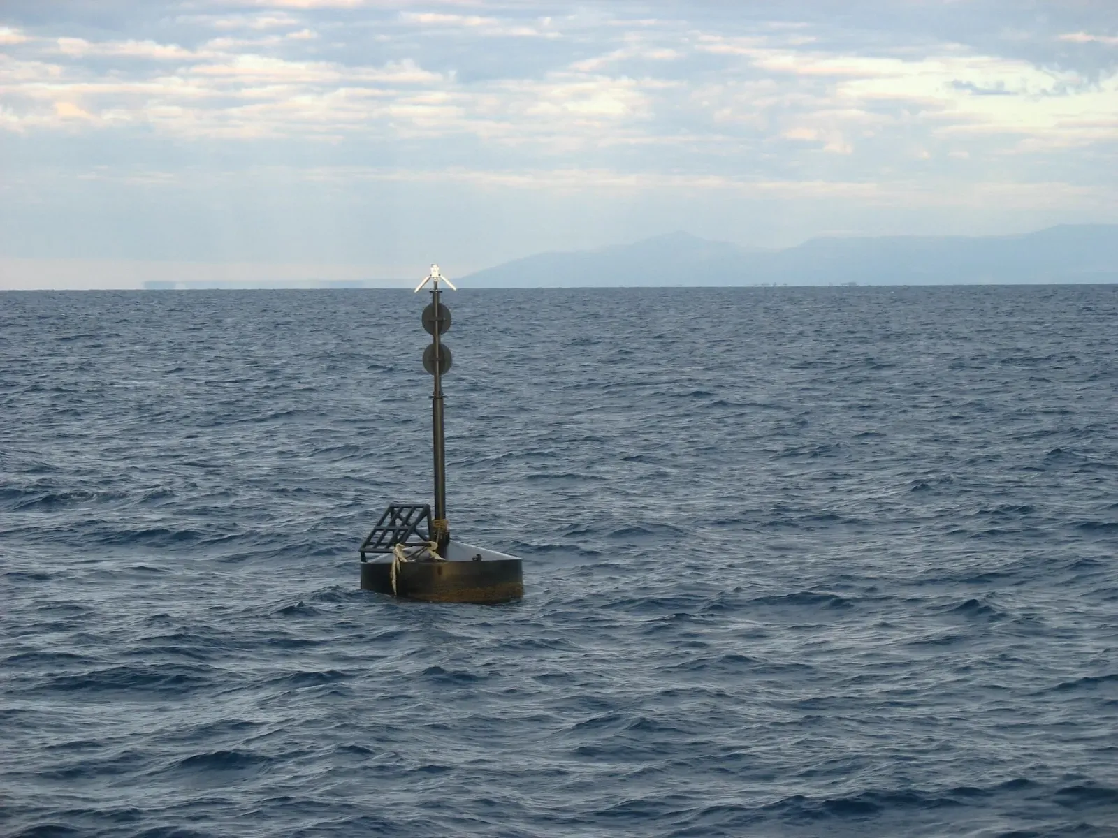 Surface mooring buoy marking the SS Yongala wreck site in open water off Townsville