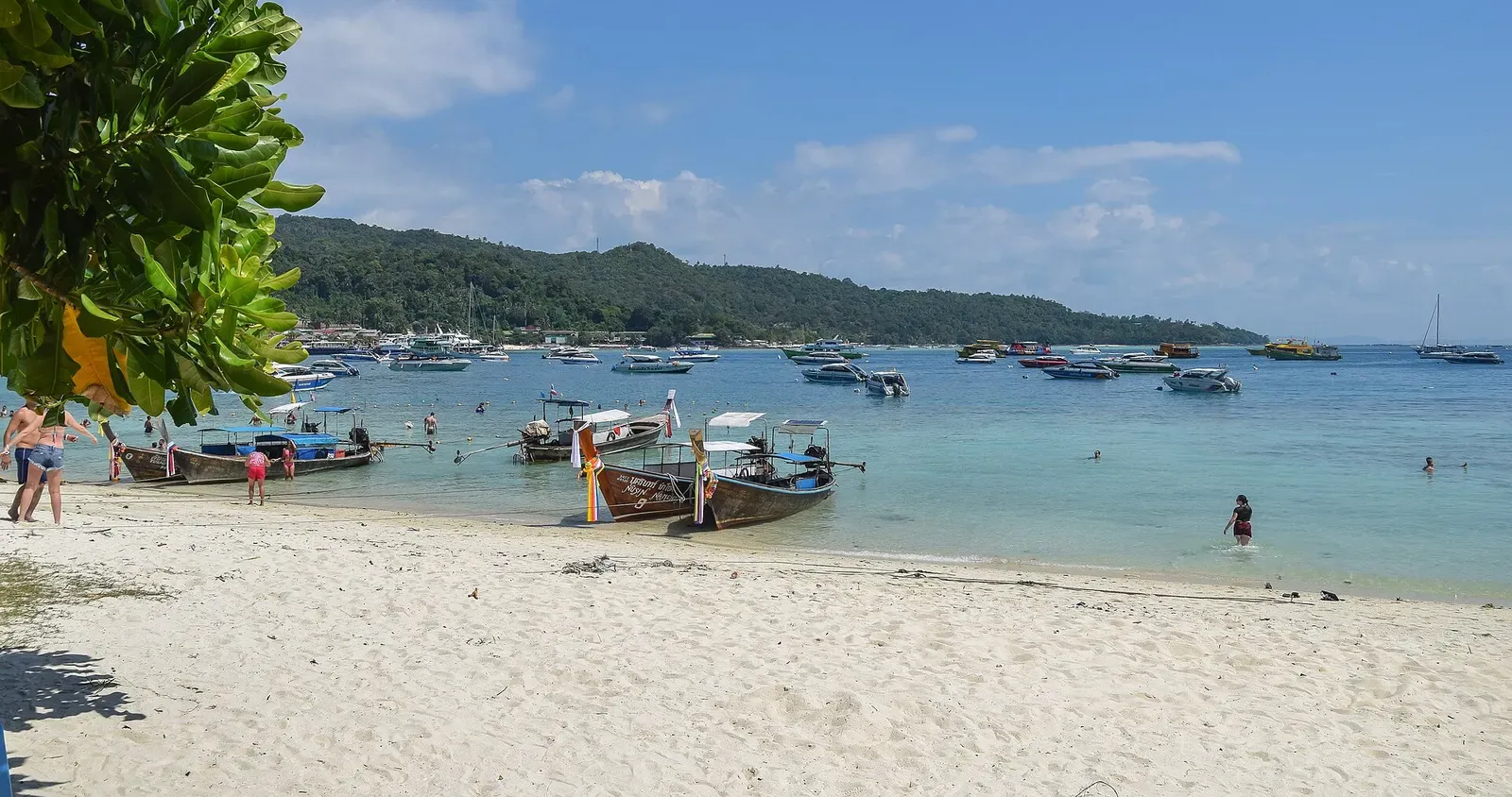 A longtail boat rests on the sand at Ton Sai beach, Ko Phi Phi Don's main harbor