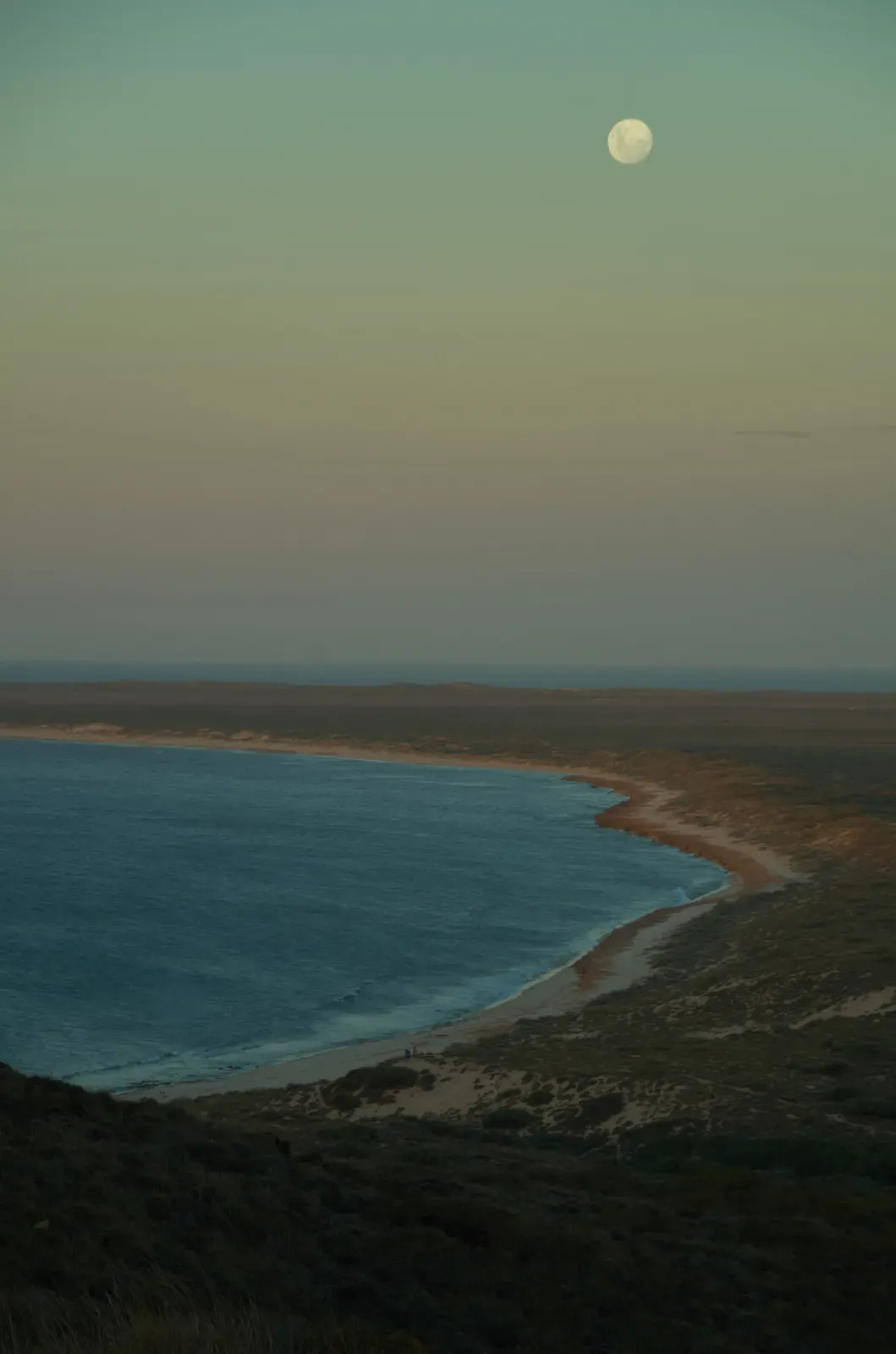 Full moon rising over a curved bay on North West Cape, seen from Vlamingh Head near Exmouth