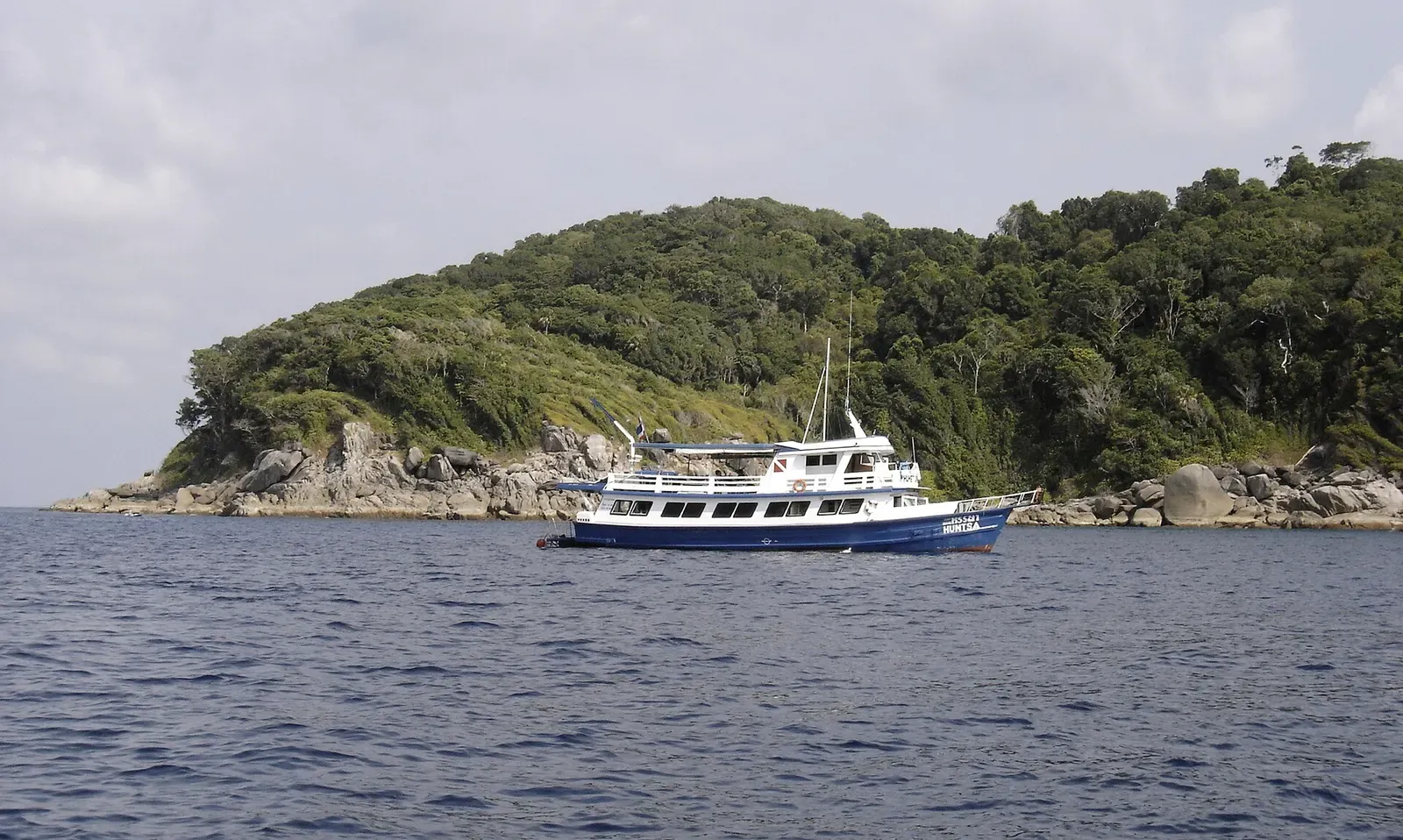A liveaboard dive boat anchored in calm water near the Similan Islands