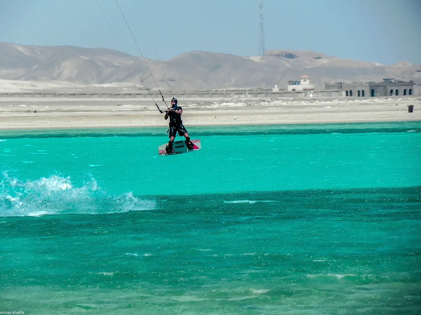 A kitesurfer rides the turquoise waters off the Marsa Alam coastline