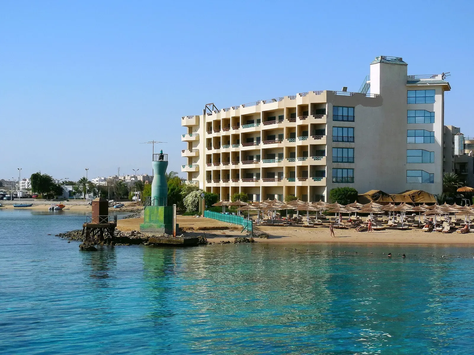 Harbor entrance marker and waterfront hotel in Hurghada, Egypt