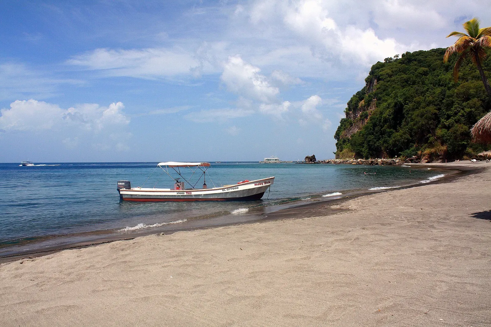 A dive boat anchored off the black-sand beach at Anse Chastanet, St. Lucia.
