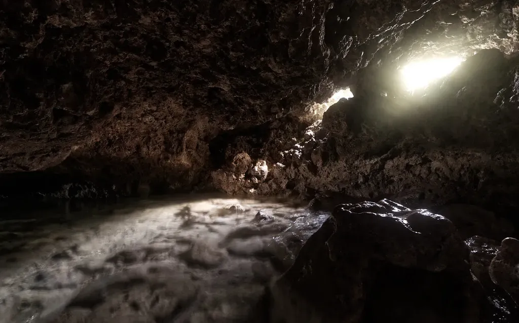 Sunlight filters into a submerged sea cave that opens onto the ocean near Puerto Galera.